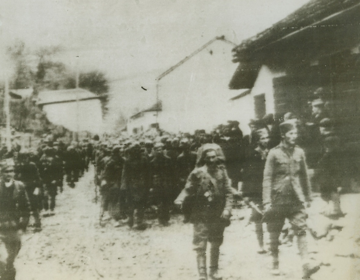 German Prisoners in Yugoslavia, 12/27/1943. Yugoslavia—Partisan detachment of troops, under the command of Tito, leads a group of German prisoners through a liberated Yugoslavian village. Villagers stop to stare at their conquered enemies. Credit: OWI radiophoto from ACME;