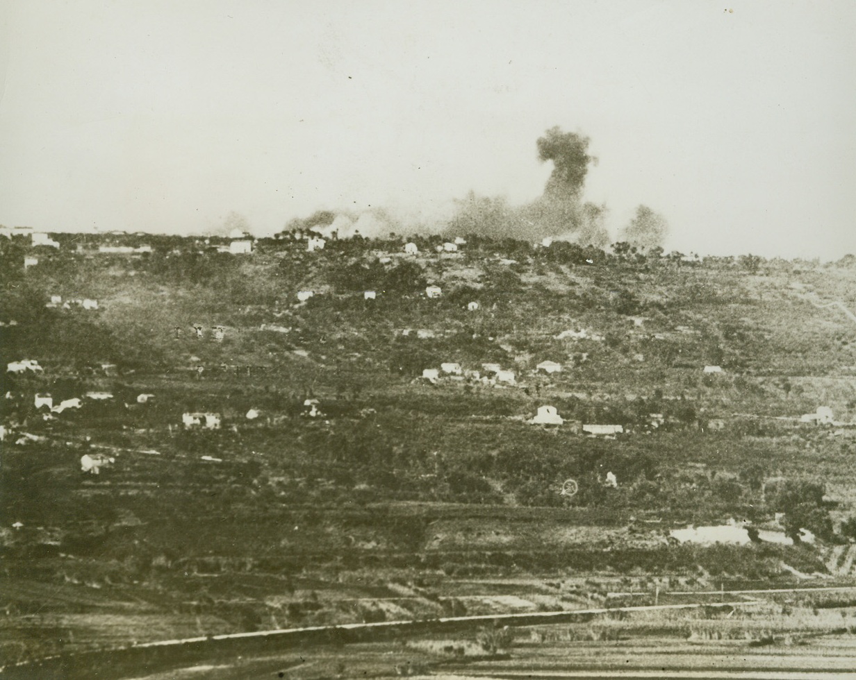 Softening Up the Enemy, 12/16/1943. ITALY – Dark smoke marks Allied bomb hits on German positions across the Sangro River (foreground) as a terrific aerial “softening-up” precedes an 8th Army advance across the Italian waterway. Looking toward Santa Maria the river, crossed by the British on November 25, can barely be seen in the foreground.  Credit Line (ACME);