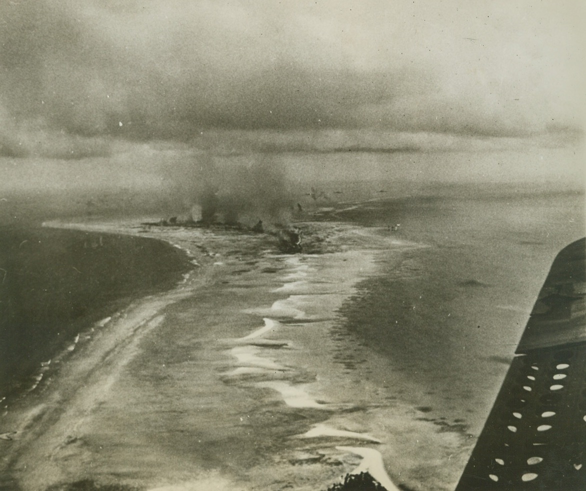 Allies Blast Tarawa, 12/16/1943. This photo, taken from the air as Allied air and sea forces bombarded the islands of the Tarawa group, shows Jap installations burning fiercely on one of the islands. In the battle, one of the bloodiest in history, U.S. Forces suffered many casualties.  Credit: (ACME) (WP);