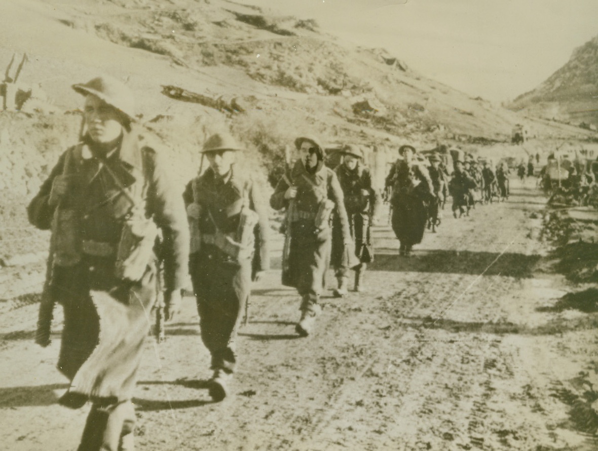 Tramping Through the Mountains, 12/2/1943. SOMEWHERE IN ITALY -- Moving up on the Italian front, a patrol of British infantrymen march on a mountain road north of Rionero. Photo radioed to New York today (Dec. 2nd) from Allied head quarters in Africa. Credit (British Army Photo via OWI from ACME);