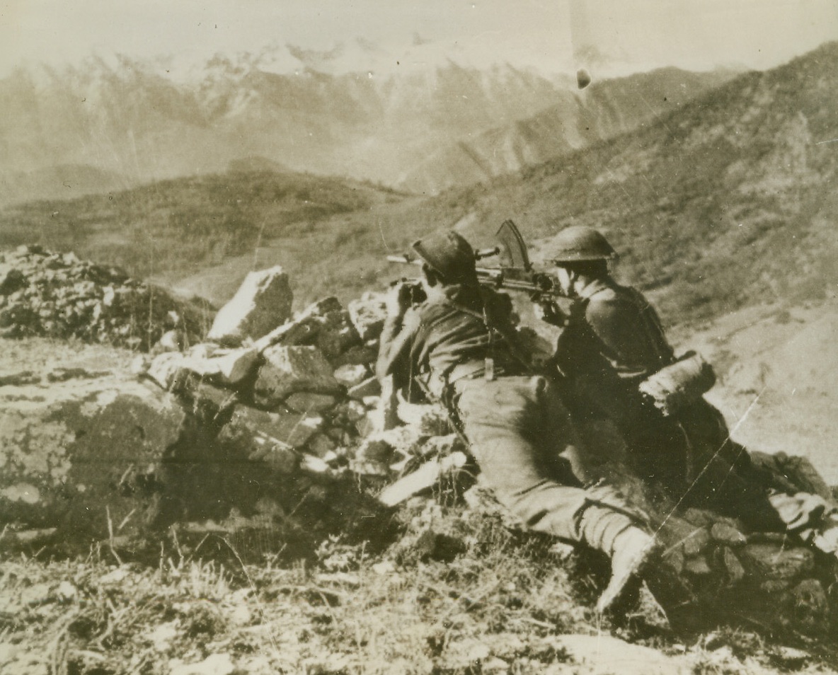 Alert Gunmen, 12/2/1943. SOMEWHERE IN ITALY -- Part of the Eighth Army's firing line on the Italian front, these British gunners lie flat on their bellies on a rocky knoll, keeping their eyes peeled for enemy action. Photo radioed to New York today (Dec. 2nd) from Algiers. Credit (British Army Photo Via OWI from Acme);