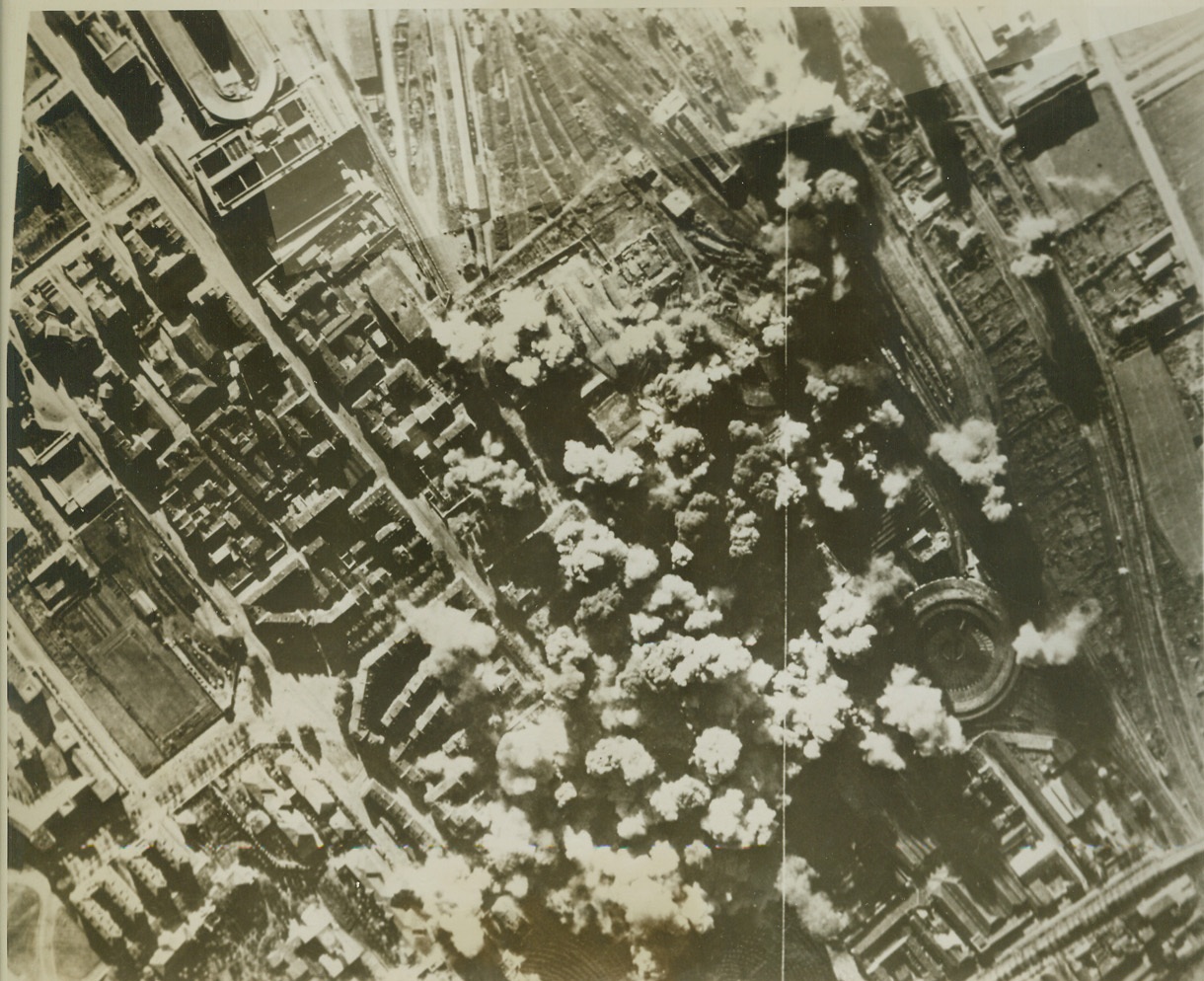 Another Crimp in Nazi Industry, 12/2/1943. This photo, just released in the United States, shows bombs from Flying Fortresses of the U.S. 15th Air Force, exploding on the important ball bearing plant and adjacent railway marshalling yard at Turin, Italy, during a raid last Nov. 8. This raid and the recent one on Schweinfurt, Germany, were aimed at cutting down the Reich's supply of ball  bearings, so necessary in  any form...(caption is torn)...warfare. Credit: (US Army Air Forces Photo from ACME);