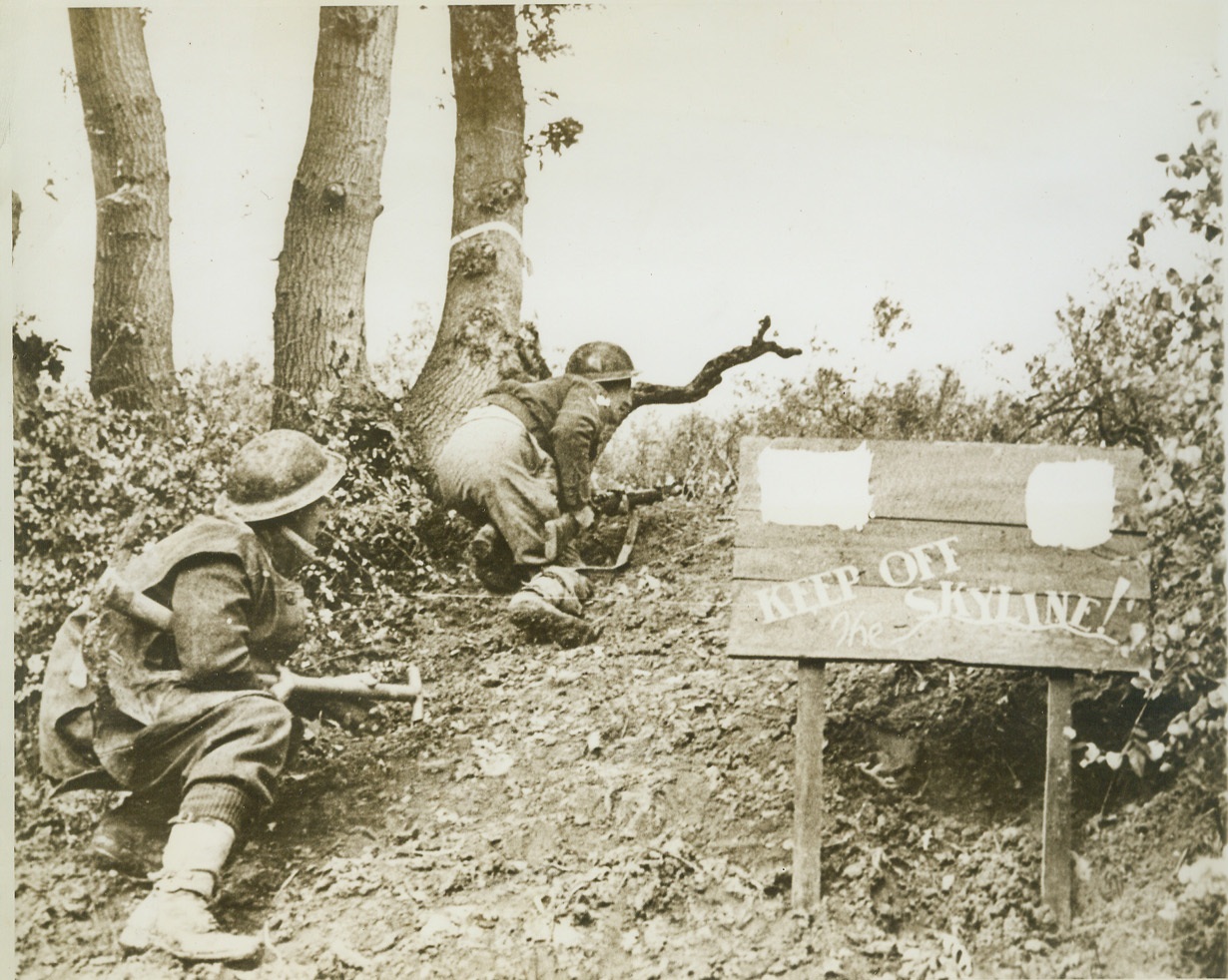 Don't Lose Your Head, 12/28/1943. ITALY -- If Allied soldiers forget to keep their heads about them mentally as they top this rise on the Sangro River firing line, they are apt to lose them physically. The "Keep off the Skyline" sign is religiously followed advice, and Gunner L.K. King, of London and Lance Bombardier T.R. Sleighholme, of Cumberland, two British 8th Army fighters, duck low to avoid Nazi shells. Credit: (ACME);