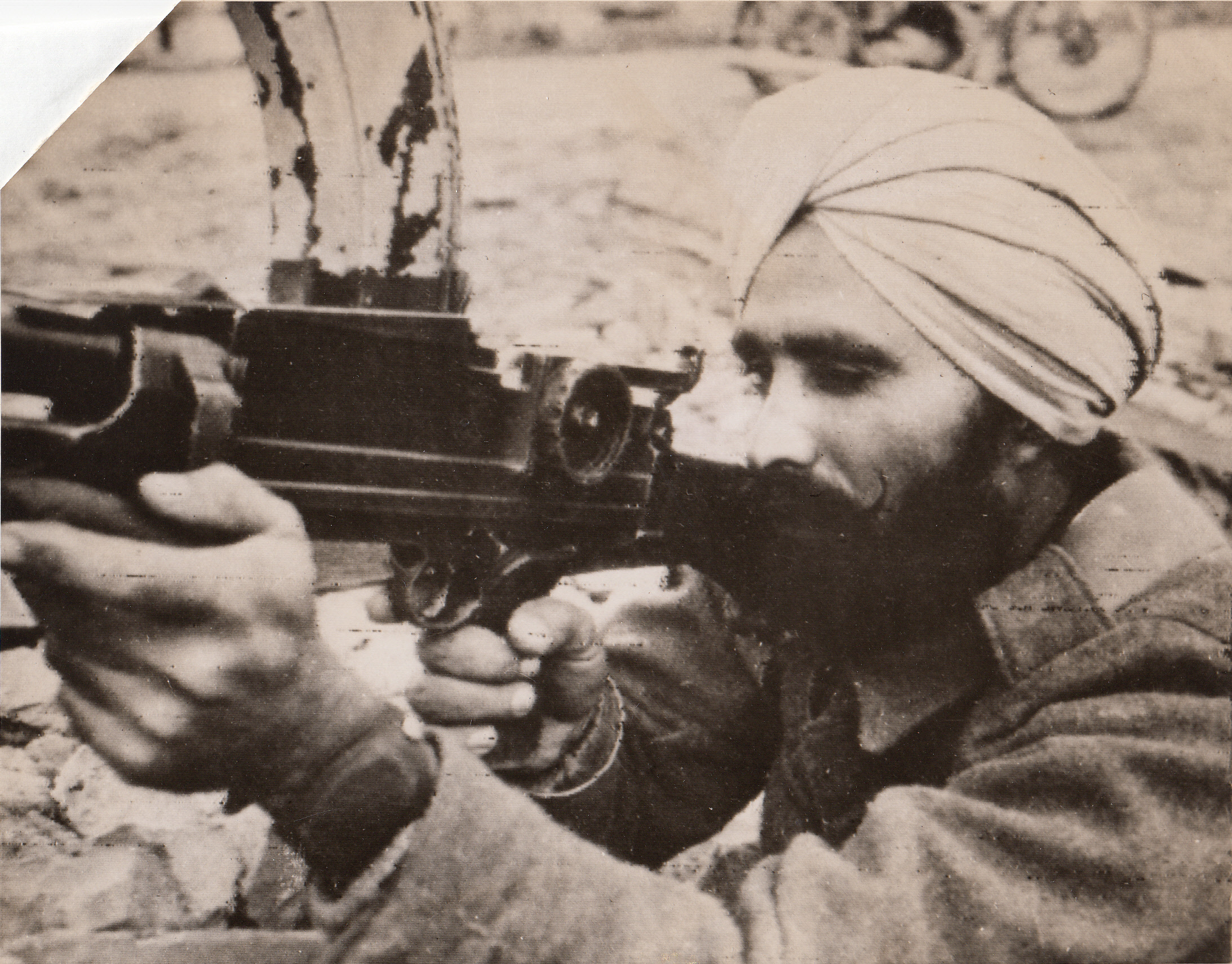 NO “TIN HAT” FOR THIS SOLDIER, 12/20/1943. ITALY—Cpl. Chain Singh (CQ), a Sikh Bren Gunner in action on the British 8th Army Front, wears no helmet but only his customary turban. The Sikhs are the only soldiers of India fighting with the Allies, who are permitted to dispense with steel head covering.;