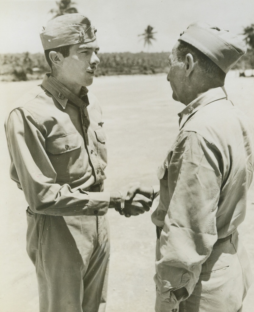 HE SHOT A NATURAL, 12/27/1943. SOUTH PACIFIC BASE—Capt. James E. Swett (left) of San Mateo, Calif., is congratulated by Maj. Gen. Ralph J. Mitchell, commanding general of Marine Air Units in the South Pacific, after being awarded the Congressional Medal of Honor at his South Pacific base. Capt. Swett received the high honor for shooting down seven Jap planes in one engagement on April 7th this year. This believed to be one of the greatest demonstrations of aerial marksmanship in World War II. Since then, Capt. Swett has added five more Jap planes to his score. Credit Line (US Marine Corp Photo from ACME);