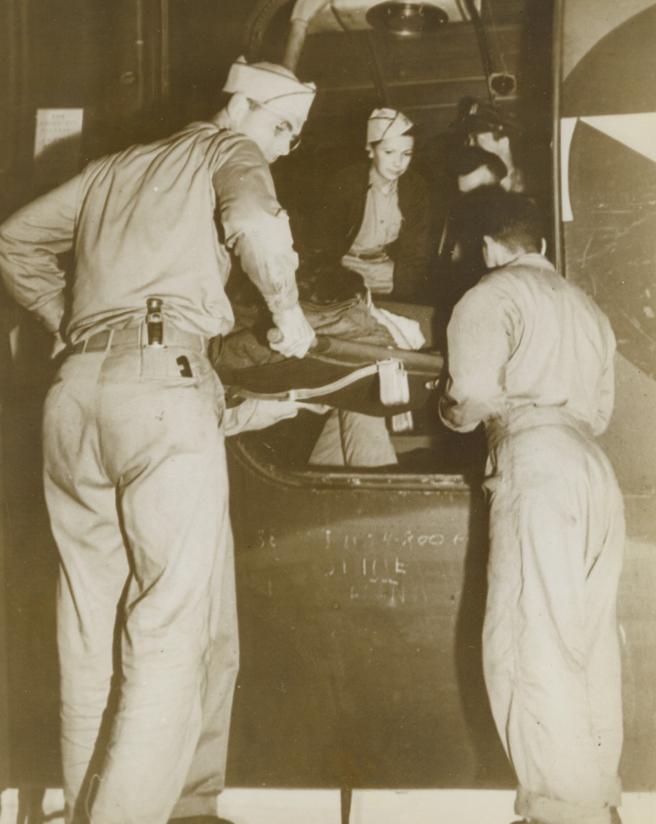 Swift Medical Care for Wounded, 12/8/1943. Hawaii: An ATC C-54 Hospital Plane takes aboard the first American casualties from the Makin Island invasion, who have just arrived from the newly-won Central Pacific base. Credit: ACME;