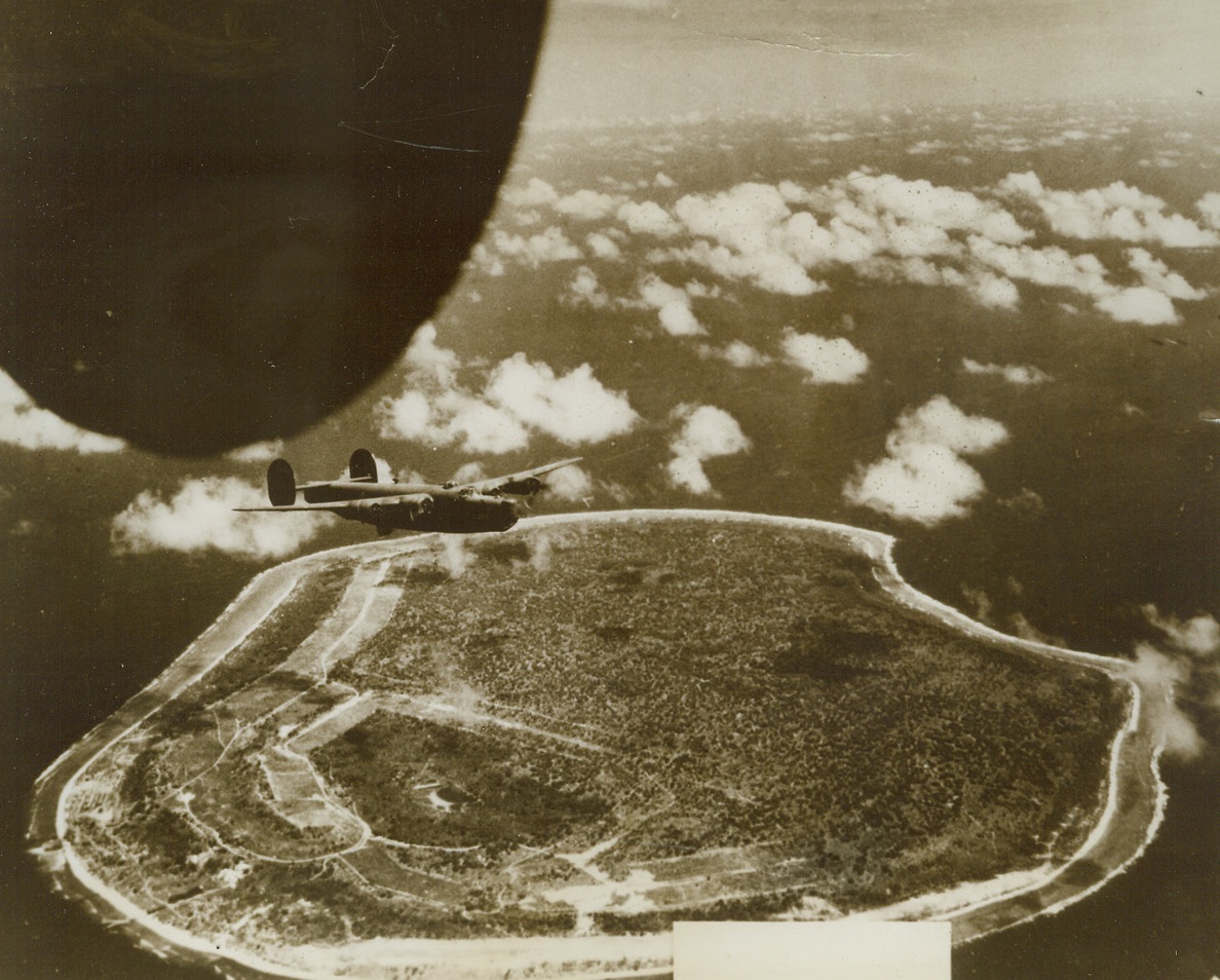 Army Bombers Raid Nauru, 12/5/1943. NAURU—As Yank forces battled for possession of Gilbert Island bases, our airmen winged over Jap-held Nauru Island, carrying out our new offensive in the central Pacific. Here, an American Liberator flies above Nauru in the raid of November 21st. Credit: USAAF photo—ACME;