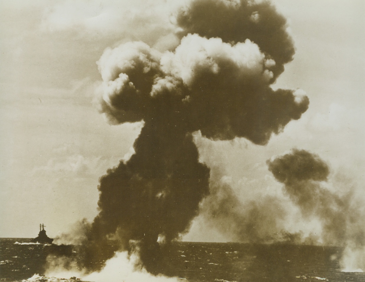 #3 – Pillar of Smoke Marks Grave of Jap Plane, 12/13/1943. All that was left of one of 72 enemy planes shot down in the December 4 U.S. aircraft carrier task force raid on the Marshall Islands was this tall column of smoke and a little debris where the Jap torpedo bomber hit the water after being blasted by an aircraft carrier’s  anti-aircraft guns. At left is a U.S. destroyer which was escorting the carrier. Credit: Official U.S. Navy photo from ACME;