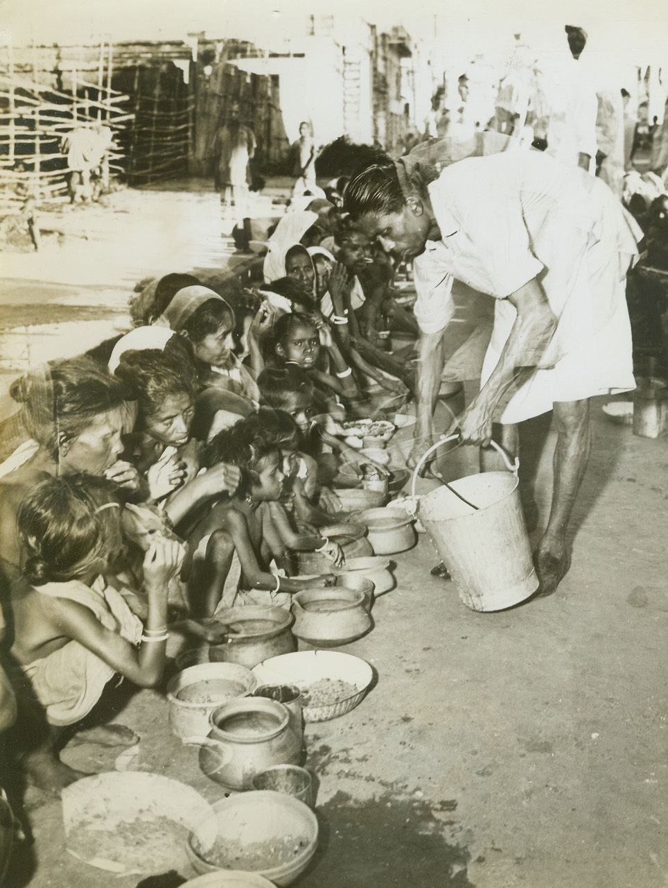 12/17/1943. By last week, an estimated 1,000,000 persons had died of starvation in India and, although the British government reportedly has the situation under control that number will undoubtedly be raised before the final, tragic count is taken.  Just released, these startling pictures were taken in Calcutta at the peak of India’s famine in late October when a homeless army of 100,000 roamed the city, dying in the streets. New York Bureau Squalid eating conditions mean nothing to India’s starving who stuff the free cereal in their mouths with their hands.  The food won’t be enough to bring their deformed bodies back to normalcy. Credit line (ACME);
