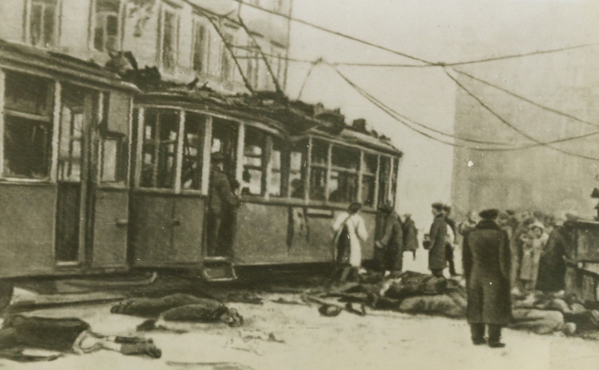 Streetcar Riders Killed by Shells, 12/15/1943. Leningrad—Bodies of citizens of Leningrad, killed when German and Finnnish guns bombarded the city recently, are piled on the street as rescue workers go through the wrecked trolley cars looking for other victims. This photo was flashed to New York by radio today. (Passed by censors). Credit: ACME radiophoto.;