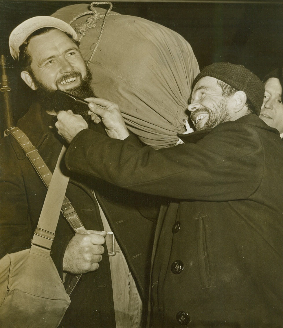 Ten-Month-Growth, 12/17/1943. New York City – Returning to the States for the first time in ten months, Carpenter’s Mate Milbert F. Baker brought a thick beard back with him. Carpenter’s Mate 3/C Edgar A. Dollar of Vancouver, Wash., Combs the face foliage of his Salem, Ore., buddy, as the two arrive in New York with the 54th Naval Construction Battalion.  12/17/43 Credit Line (ACME);