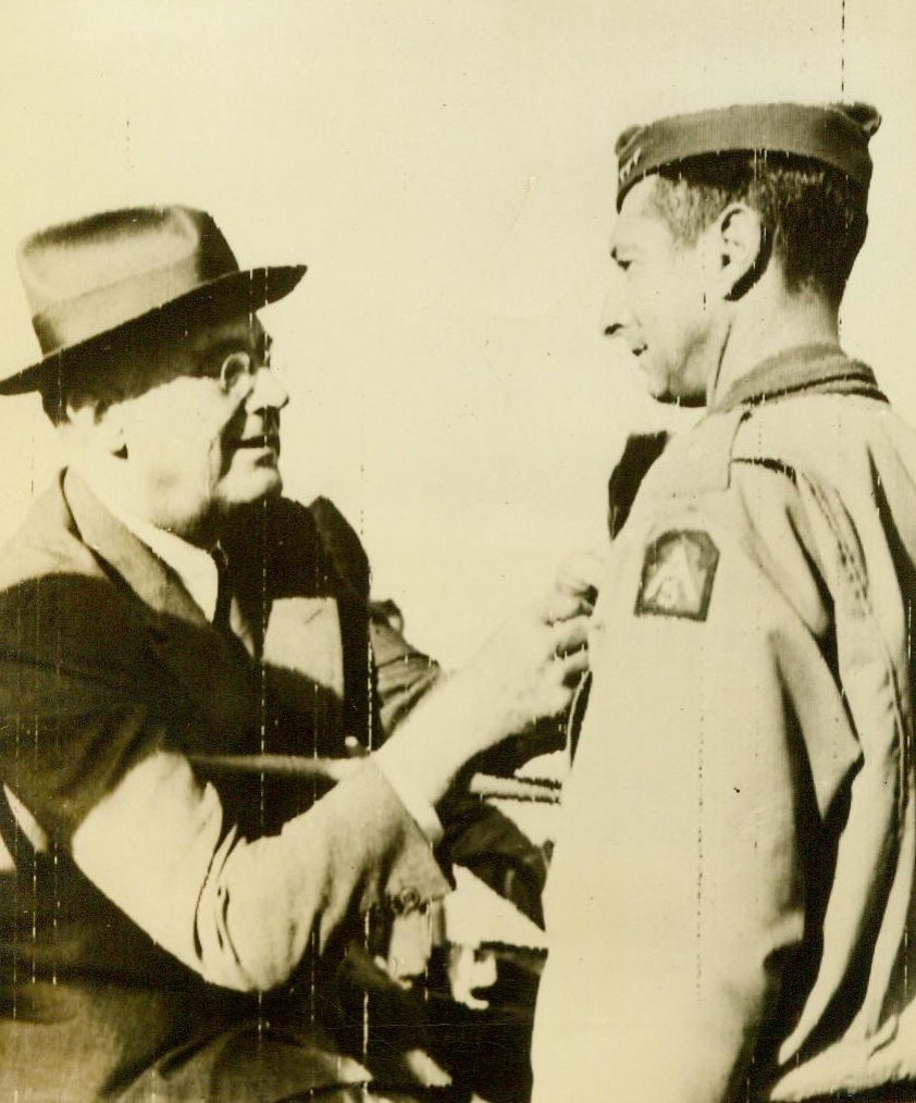 Decoration by The "Chief", 12/13/1943. Castelvetrano, Sicily—President Franklin D. Roosevelt leans out of his jeep to pin the Distinguished Service Cross on the field jacket of Lt. Gen. Mark Clark (Right), USA, commanding General of the Allied Fifth Army, in ceremonies at Castelvetrano, during the Chief Executive’s stop-off in Sicily on his way home from the historic Cairo and Teheran Conferences 12/13/43 (ACME);
