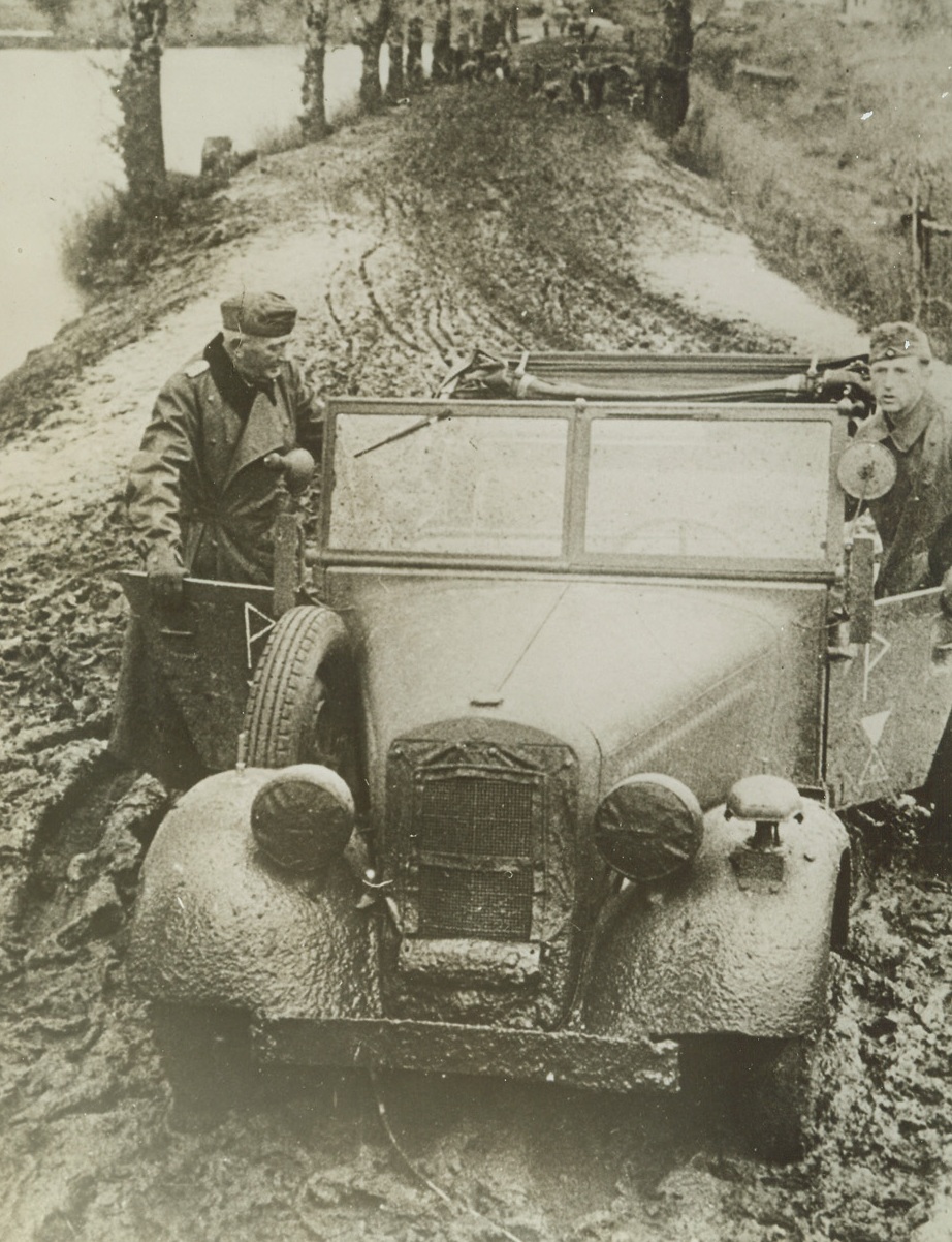 “Anybody Got a Sponge?”, 1/3/1945. Russo-German Front—This may give you some idea of the difficulties besetting the Germans on their round-trip into Russia. This officer and his driver had to get out and walk when their reconnaissance car bogged down in the famed Russian mud. They should have stayed home. Passed by German censor. Credit: ACME.;