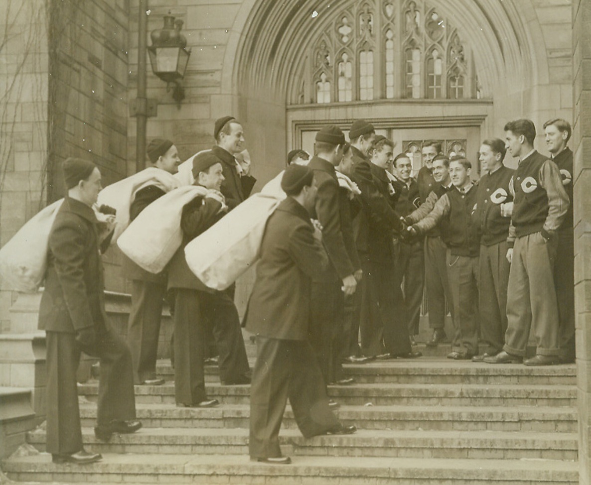 No title. 1/6/1945. Chicago—University of Chicago lettermen welcome some of the 500 coast guardsmen to their campus dormitory, Burton Court, where the seamen will live until their base training period at the nearby U.S. Coast Guard station is completed. The Coast Guard, now an active fighting unit of the U.S. Navy, is training men for coast defense as well as rescue work. Credit: ACME.;