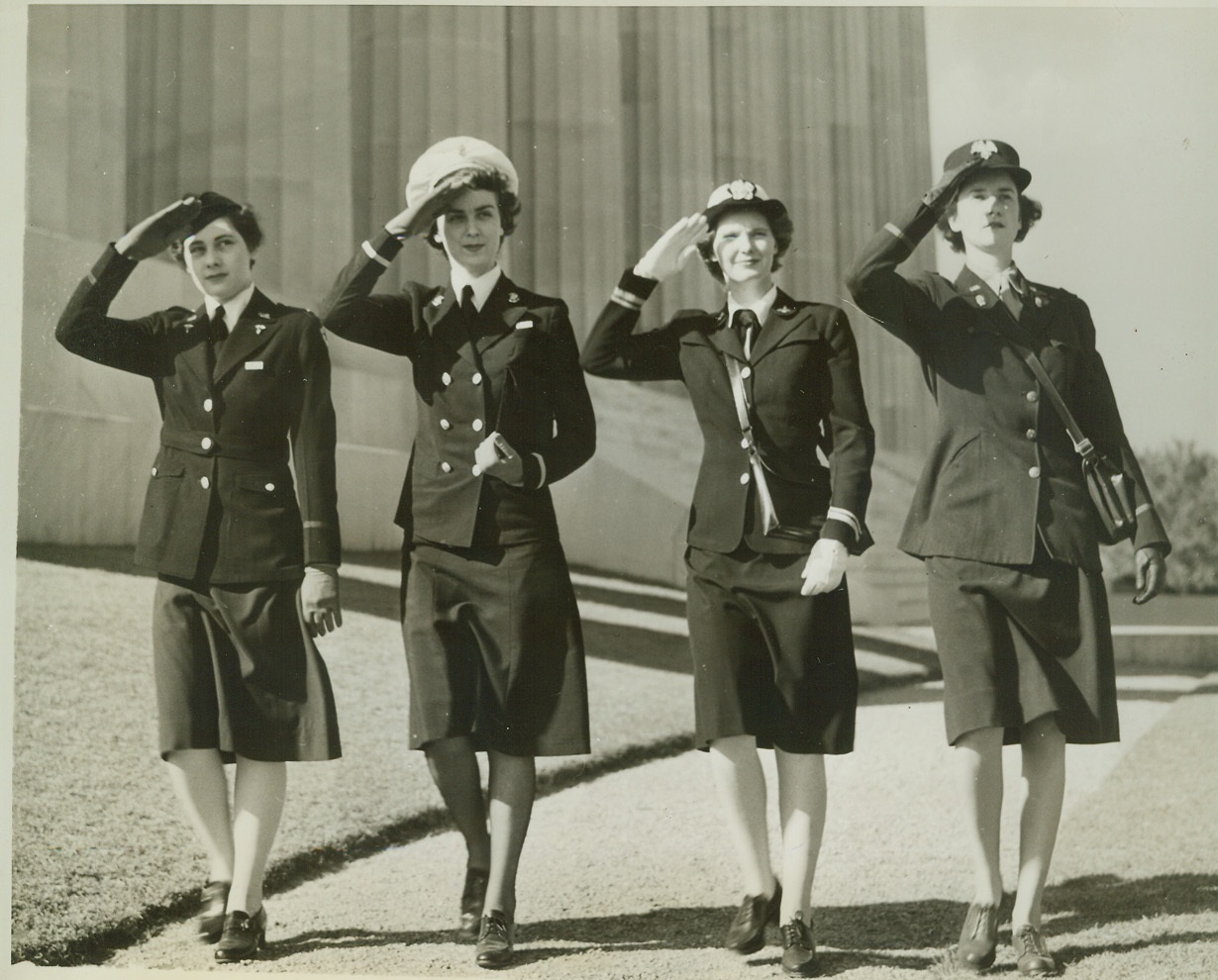 FEMININE SERVICE UNIFORMS, 10/10/1942. WASHINGTON—Attractive, Utilitarian, and Modern are the uniforms that have been approved for wear by the women who are members of the auxiliaries of the U.S. Armed Forces. Here the outfits of the Army Nurse, Navy Nurse, WAVE, WAAC, (Left to Right)- are displayed respectively by Lt. Doris Hyde of Lancaster, PA., Ensign Mary E. Hill of Elizabeth City, N.C., Lt. (JG) Marion Enright of Forest Hills, NY and Third Officer Alberta Holdsworth of Boston, NY. Credit: OWI Radiophoto from ACME;