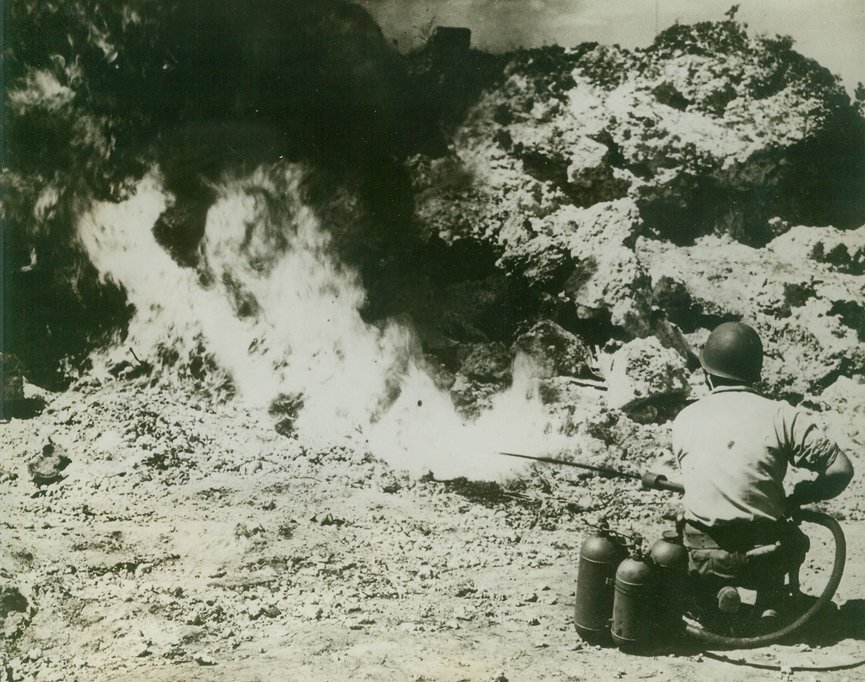 BATTLE RAGING IN THE SOLOMONS, 10/15/1942. United States Forces are striving to prevent the Japanese from landing reinforcements on Guadalcanal. The above photo just released by the U.S. Navy shows a U.S. Marine demonstrating that a Japanese flame-thrower, captured after the battle of Tenaru, is an effective weapon.  Credit Line (U.S. Navy Official Photo from ACME);