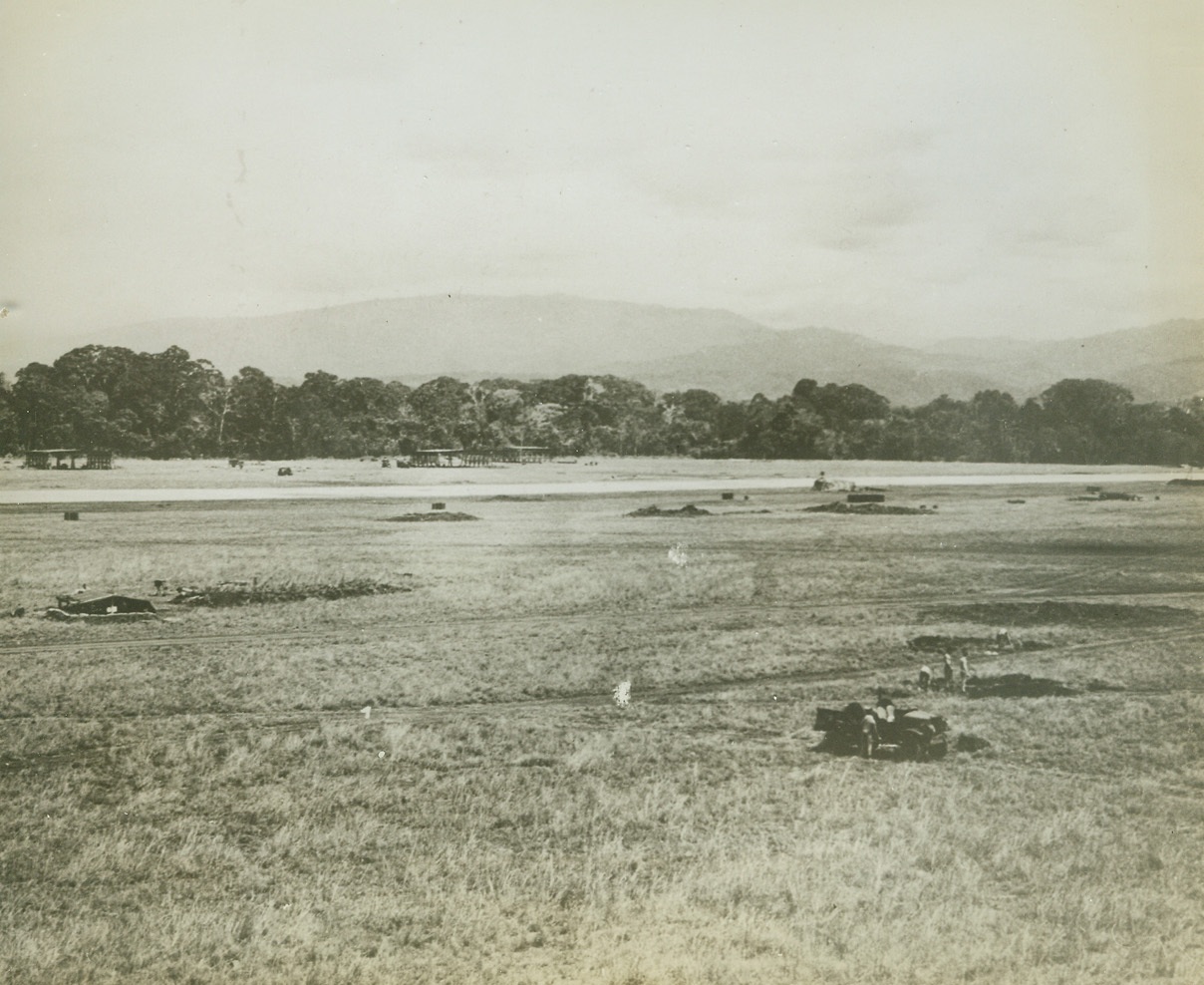 Battle Raging in the Solomons, 10/15/1942. United States forces are striving to prevent the Japanese from landing reinforcements on Guadalcanal. The above photo just released by the US Navy shows the highly strategic airfield on Guadalcanal which U.S. Marine wrested from the Japanese during the forepart of operations in the Solomons islands.  The Japanese within the past two days have repeatedly bombed and shelled the field and other Marine positions.  This photo shows Marines filling in shell holds made during earlier fighting.Credit Line (U.S. Navy official photo from ACME);