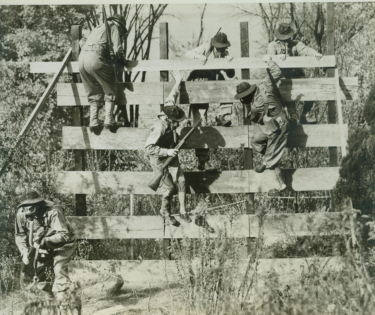 College Commandos Cut Capers, 10/16/1942. Madison, Wisc. – It’s up and over the hard way for the Wisconsin Rangers, unique unit of the University of Wisconsin’s ROTC, patterned after the American Rangers now in foreign service. Wearing gas masks, the Badger cadets carry Garand rifles, Tommy-guns and Walkie-Talkies in their equipment as they maneuver across a 400 yard obstacle course built on the Wisconsin campus. Credit: (ACME);