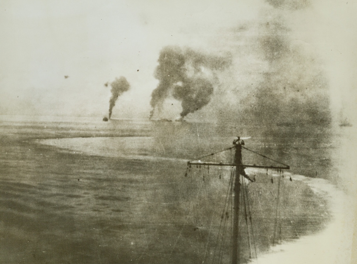 Torpedo Bomber Attack, 10/17/1942. Solomon Islands – The sharply–curving wake of an Australian Cruiser shows how the vessel twisted and turned to avoid a Jap torpedo-bomber attack during the fighting in the Solomon Islands. Columns of smoke rise from three downed bombers. Credit: ACME;