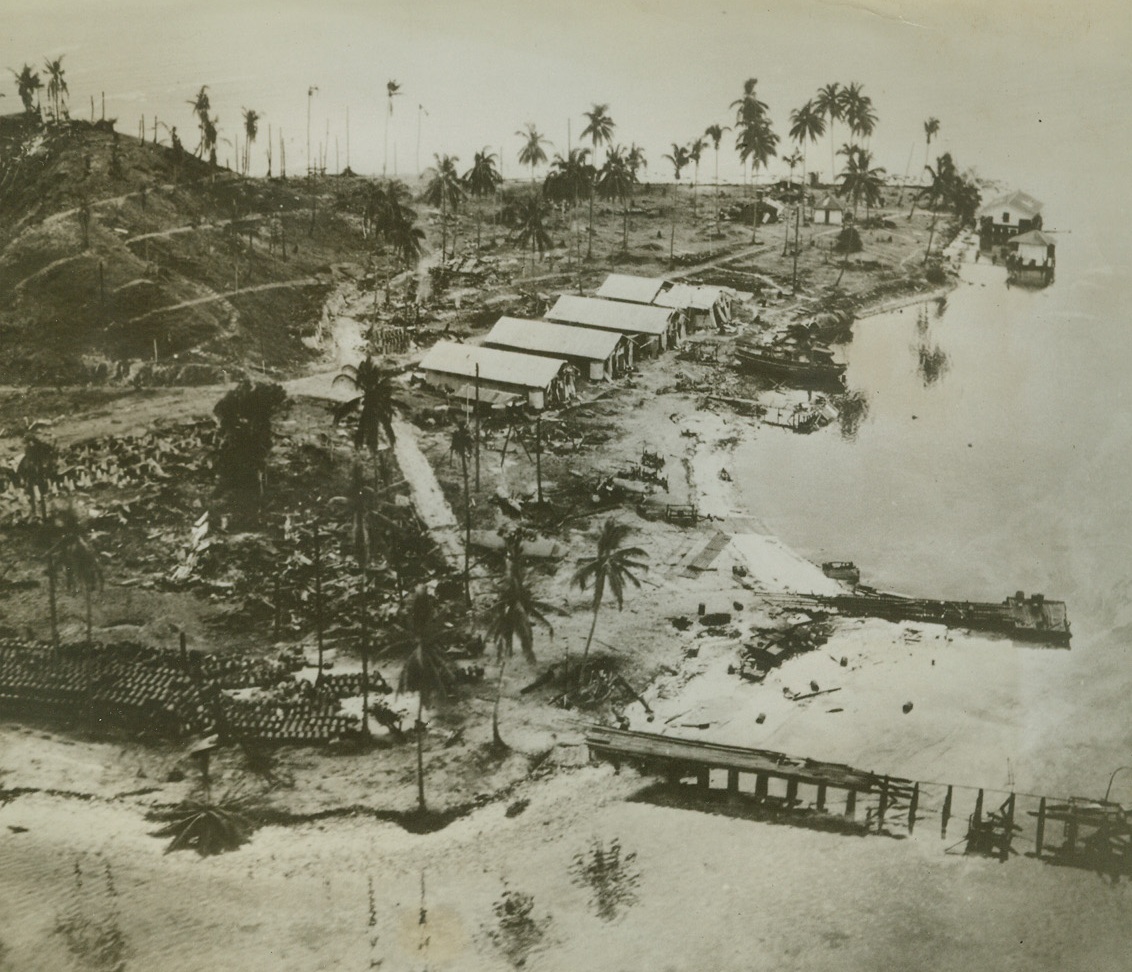 Damage to Japs in Solomons, 10/17/1942. Solomon Islands – Buildings and piers on the Jap-held Tanambago island show the wreckage caused by heavy bombing attack of American airmen.  The raid was part of the U.S. drive on the Solomons.Credit (Official US Navy photo from ACME);