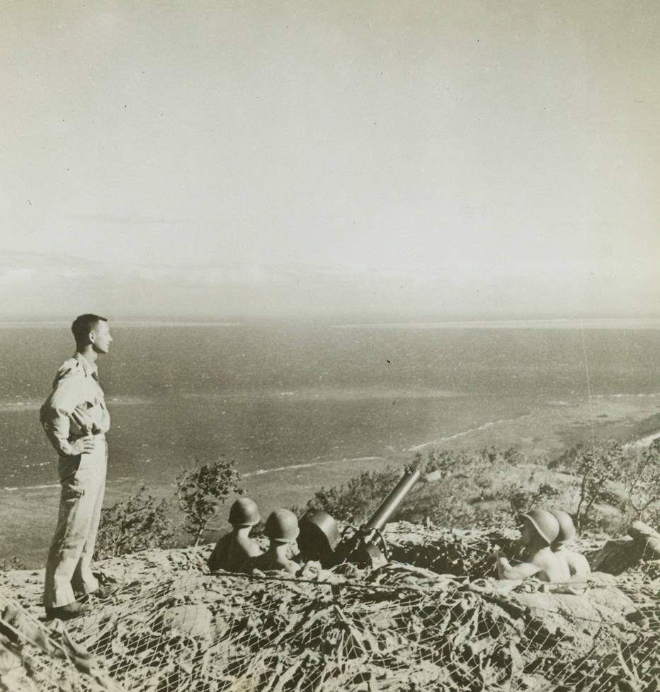 High Watch, 10/21/1942. New Guinea – U.S. Anti-Aircraft Gunners watch the skies high above Port Moresby’s shore. Below them lies the Coral Sea. Lawrence B. Kelly, of Bainbridge, GA., stands over the gun crew at left. Credit: ACME;