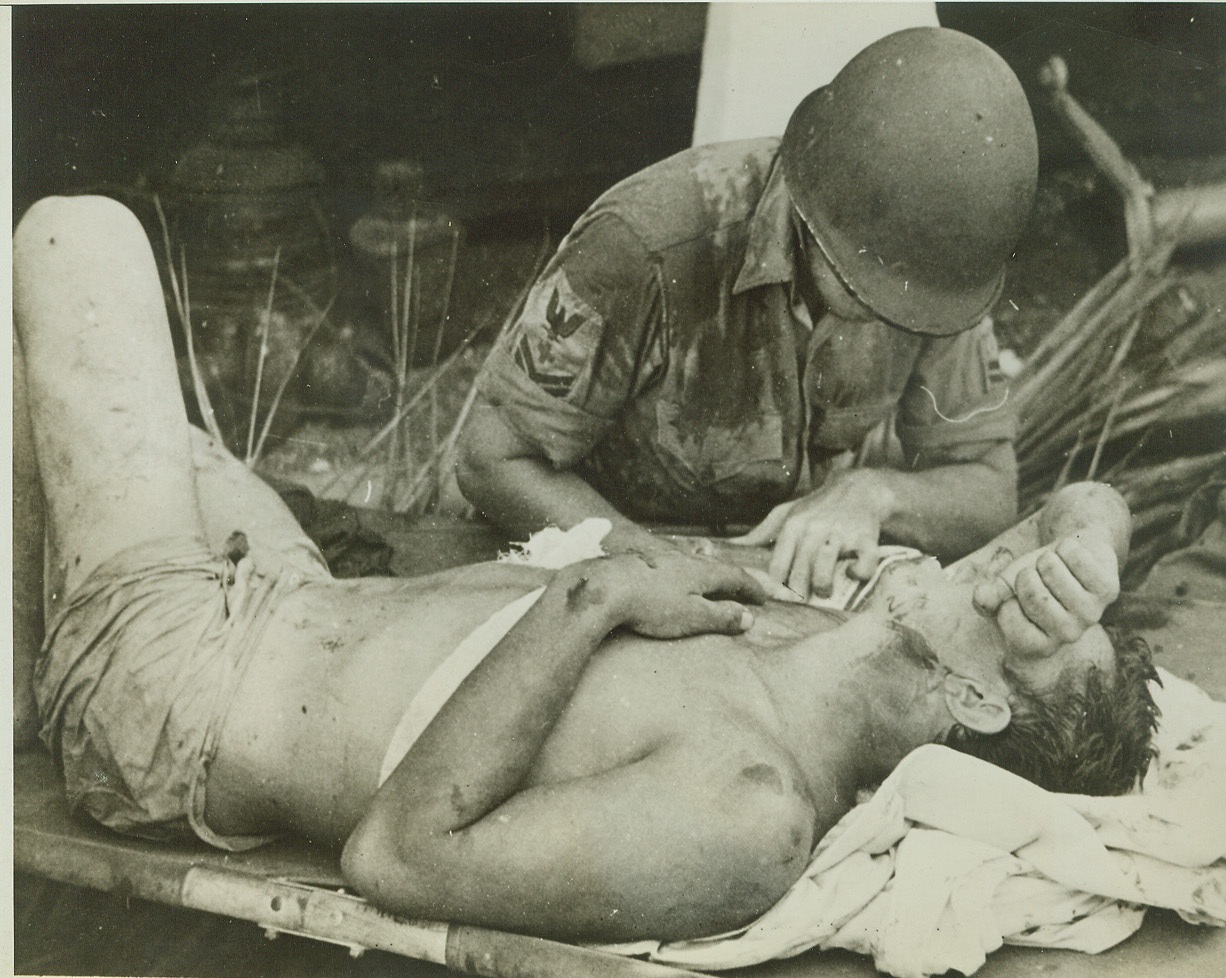 Survivor of U.S.S. Calhoun Gets First Aid, 10/6/1942. A survivor of the U.S. Navy Auxiliary vessel, U.S.S. Calhoun, sunk by Jap bombers early in the fighting in the Solomon Island area, is given first aid at Guadalcanal after his rescue.  Credit: (ACME);
