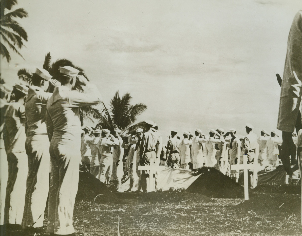ISLAND BURIAL FOR NAVY DEAD, 10/16/1942. United States sailors salute as four of their shipmates, killed during naval engagement in the Solomon Islands area, are laid to rest on a colorful tropic island somewhere in the South Pacific.Credit: OFFICIAL U.S. NAVY PHOTO FROM ACME.;