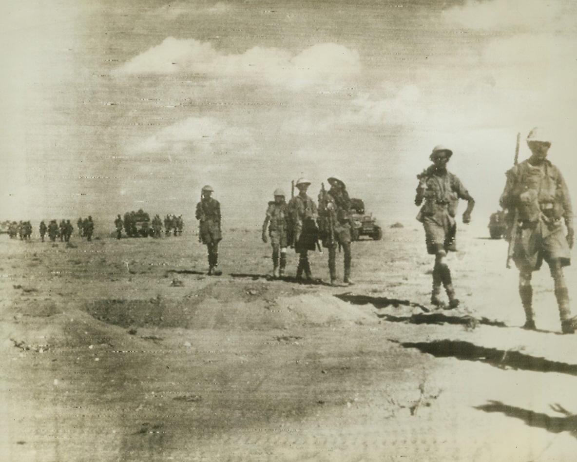 Rommel Being Pushed Back in Desert, 10/29/1942. Egyptian Front – British 8th Army infantry and trucks are shown as they forged ahead on the offensive against German forces in Egypt, in this photo flashed by radio from Cairo to New York, Oct. 29.  In spite of axis counterattacks, United Nations forces are still advancing through German minefields.Credit line (ACME radio photo);