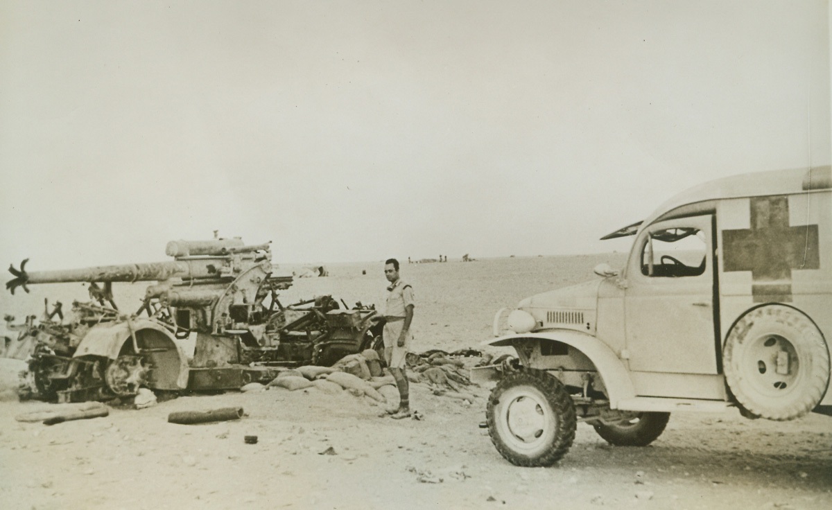 He Found No Wounded, 10/25/1942. North Africa—A volunteer ambulance driver with the American Field Service finds no wounded as he drives up to the Nazi gun, destroyed by Allied forces in the Middle East.Credit: ACME.;