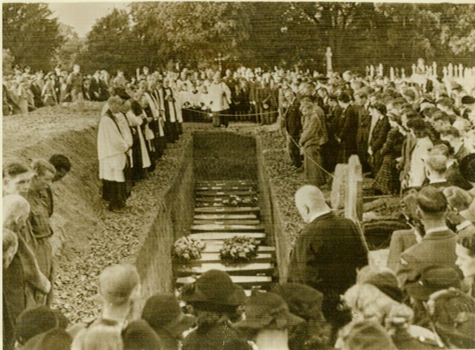 Mass funeral of English schoolchildren, 10/3/1942. ENGLAND - Solemn crowds attend the funeral (above) of 30 victims of a daylight raid on a school in southern England. The headmaster, Charles Stephenson, and a teacher, Charlotte Marshall, were killed together when a German bomb struck the school.;
