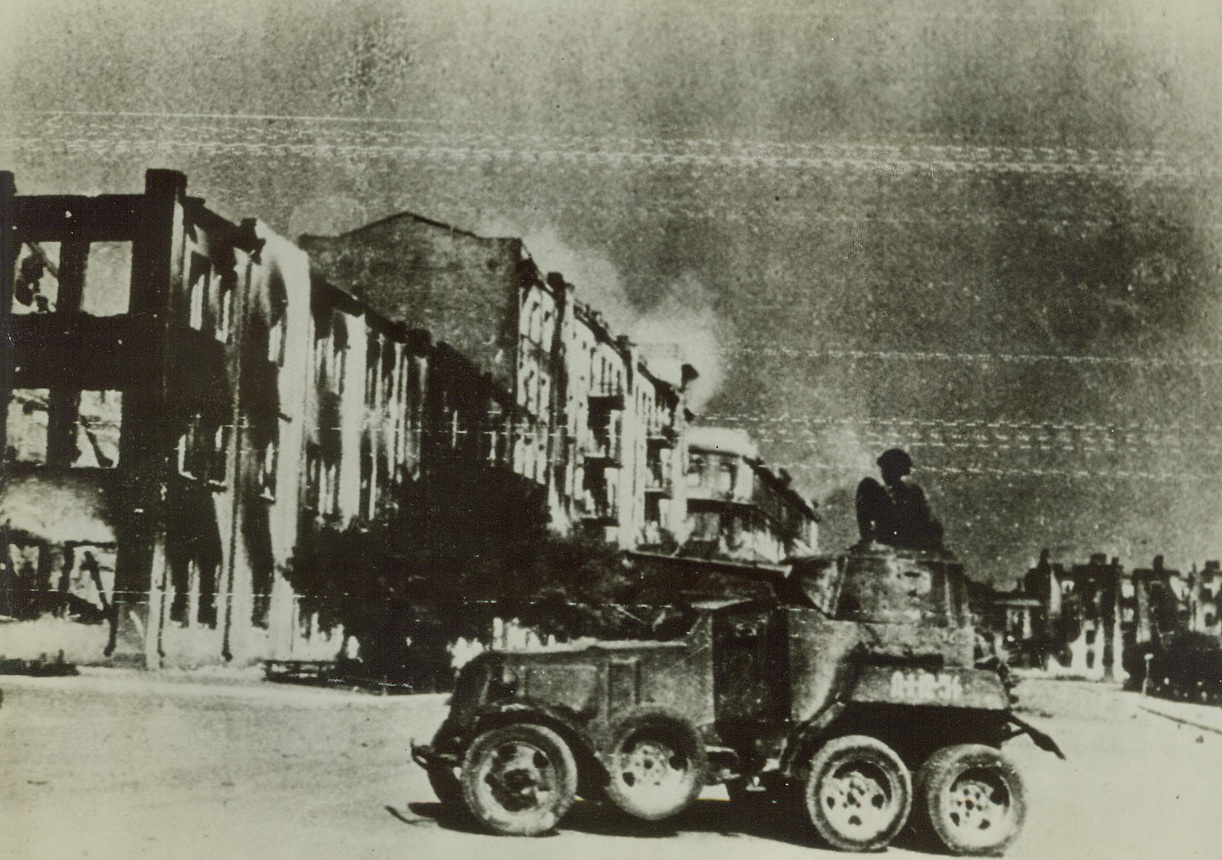 In Embattled Stalingrad, 10/19/1942. Stalingrad—A Russian armoured car patrols the deserted streets of Stalingrad. Note the wrecked, fire-scarred buildings that still stand in spite of the terrific pounding of Nazi bombs and gunfire. Credit: ACME.; Stalingrad—A Russian armoured car patrols the deserted streets of Stalingrad. Note the wrecked, fire-scarred buildings that still stand in spite of the terrific pounding of Nazi bombs and gunfire. Credit: ACME.;