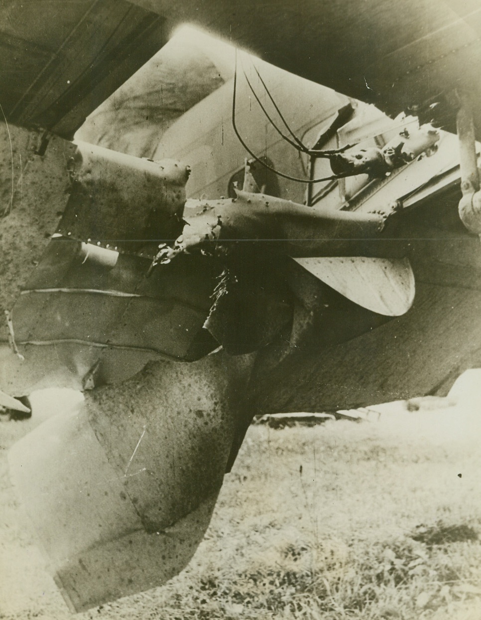 R.A.F. Bomber Flew Home With Hole in Wing, 10/4/1942. England—This gaping hole was torn in the wing of a Hudson Coastal Command bomber by a medium size shell while attaching a German convoy that was creeping in at night up the Dutch coast with supplies for Nazis on the German front. No one was wounded and despite the damage, the pilot brought the ship home safely. (Passed by censors). Credit: ACME.;