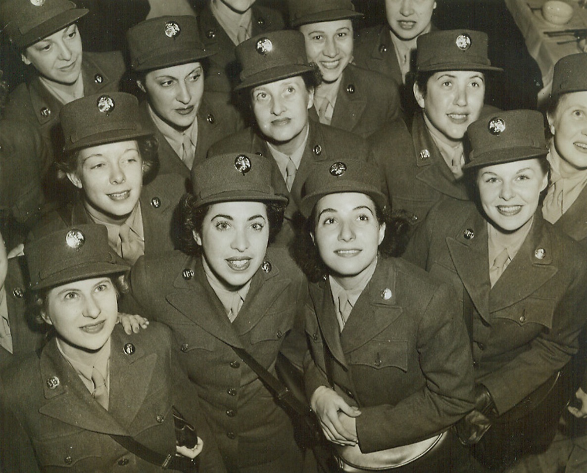 The WAACS Are Back, 10/16/1942. New York—Fresh out of Des Moines, the first contingent of war-trained WAACS hit New York City today. Trim in their caps and uniforms, about 100 military misses stepped forth in Grand Central Station, and gaily sang camp songs in the new Army Induction Center in the Grand Central Palace Building.Credit: ACME.;