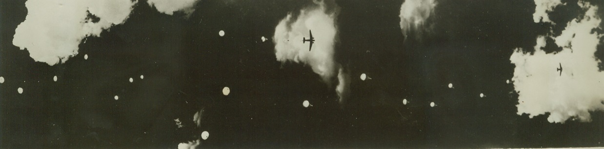 Canadian Paratroopers Train at U.S. School, 10/12/1942. Fort Benning, Georgia – Canadians, who will form the nucleus of the first paratroop unit in the Canadian army, are now in training in the U.S. Army school at Fort Benning. The men will serve as instructors in the school at Camp Shilo, Manitoba, Canada, as soon as they have finished the course here. In this photo, Canadian paratroopers float toward the ground after bailing out of huge transport planes. Credit: ACME;