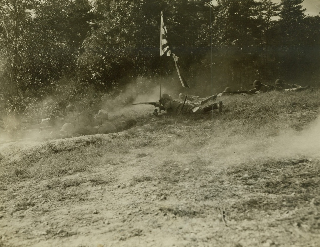 Yanks Get Taste of “The Big Show”, 10/12/1942. Fort Belvoir, Virginia -- Soldiers at Fort Belvoir got a taste of what’s ahead of them when Warner Bros. staged a battle scene  for the forthcoming government picture  “The Fighting Engineers.” As Japanese to play the part of Japs were a bit scarce in the neighborhood, 50 Filipinos were brought in to play the parts of the “enemy.” So realistic were the battle scenes that the U.S. soldiers had to be cautioned continually to go easy with their bayonets. To make it even more realistic, battle scenes were staged in a section of Fort Belvoir that closely resembles the terrain of the Solomon Islands. The U.S. soldiers were, of course, the victors in the movie. Here, a series of photos taken during the filming is presented. Passed by Army censors.  New York Bureau The battle is on and “enemy” machine gunners train their weapon on the U.S. Engineers. A real Japanese machine gun was used in this scene. Several “takes” were ruined because it was continually jamming. Credit: ACM;