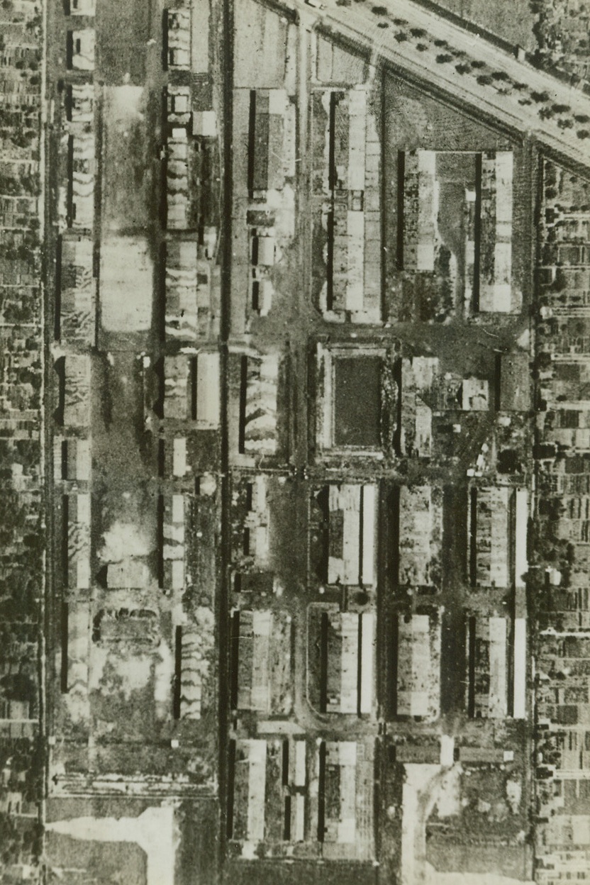 FOCKE-WULF WORKS BLASTED BY R.A.F….#1, 10/25/1942. LONDON – Before the R.A.F. attack on the Focke-Wulf works at Neu England near Bremen, photographic reconnaissance shows single storey sheds probably used to store materials.  The September 13 bomber command raid caused extensive damage to the axis plane manufacturing center.  Credit: Acme;