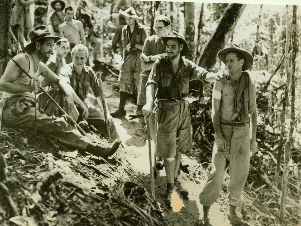 Wounded Aussies on way to rear area, 10/7/1942. NEW GUINEA – Wounded Australian soldiers on their way back from the front lines after engaging the Japanese in the Kokoda area. This is one of the first photos of the men wounded in that section. The men had to walk for almost six days through dense jungle and mountain valleys to reach the base hospital. CREDIT LINE (ACME) 10-7-42;