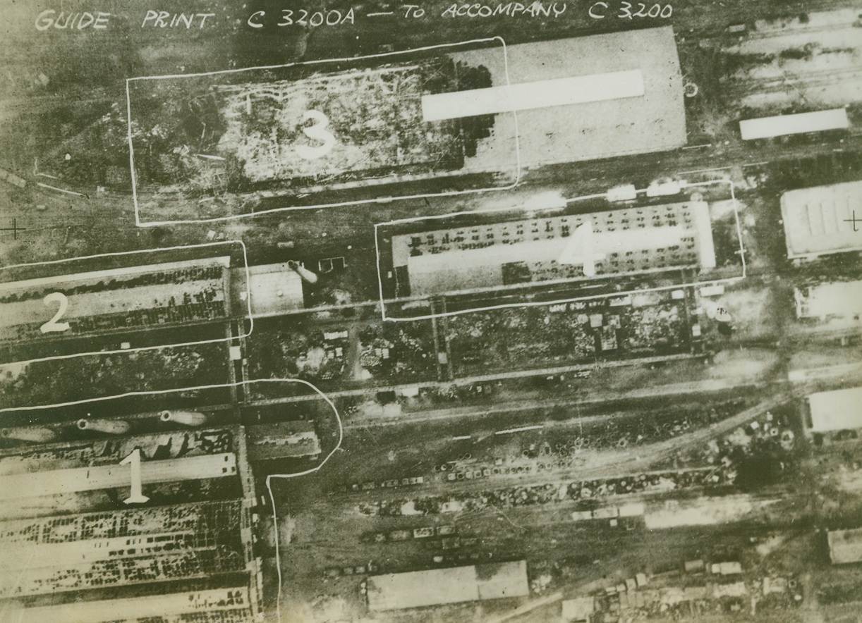 Breuil Steelworks Damaged in Krupps Raid, 11/10/1942. LE CREUSOT – Heavy damage was done to the steelworks at Le Creusot on October 17 when the three main sections of the valuable “Krupps: plant were blasted by 94 RAF Lancaster bombers. This reconnaissance photo shows the damaged sections of the Breuil steelworks – one of the three steelwork branches. A direct hit destroyed half a warehouse, another leveled the south end of the steelworks, while a severe blast damaged an adjoining shed and another warehouse.Credit Line (Acme);
