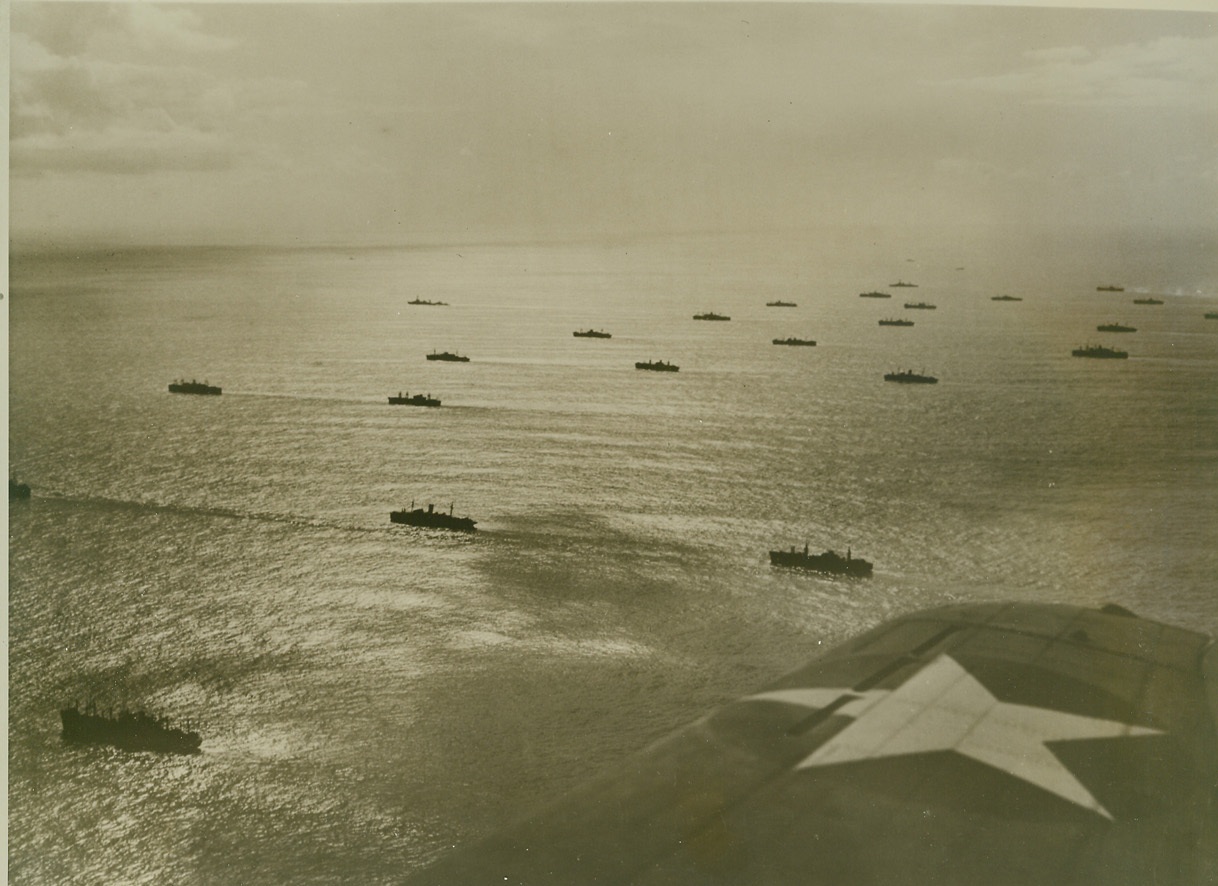 DESTINED FOR AFRICA, 11/26/1942. Steaming in perfect formation, a huge United Nations convoy plows through the Atlantic Ocean, bound for Africa, where troops were landed in French possessions the first part of November. The convoy was well escorted by sea and air, as shown by this aerial photo of the remarkable sea expedition, which reached all ports virtually unscathed. Credit: ACME official U.S. Navy photo;