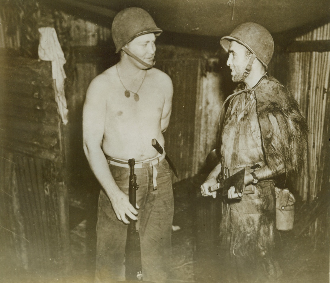 Marine Models Jap Sniper’s Uniform, 11/4/1942. In this photo just released in Washington, one Marine, (right), models the uniform made of the skin of a long-haired animal, which is worn by Jap snipers. Picture was taken on “some battlefront.” Credit: U.S. Marine Corps photo from ACME;