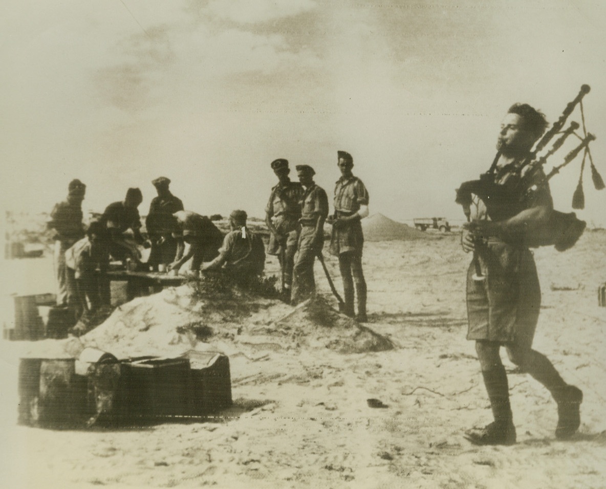 Bagpipes Sound the Call to Arms, 11/1/1942. North Africa – Instead of the traditional fanfare of trumpets, the music of bagpipes leads men of the highland division in attacks in the Western desert.  The piper at the right and others like him have distinguished themselves in leading their division in the last few days.Credit line (ACME radio photo);