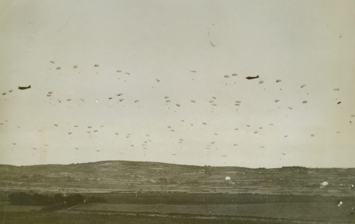 Floating to Earth, 11/7/1942. North Ireland—Hundreds of billowing parachutes float slowly toward the green fields of Ireland. Training to be invaders, these Yanks complete a jump successfully, which brings them one step closer to admittance into the U.S. Patatrooper Force. (Passed by censor) Credit: ACME.;