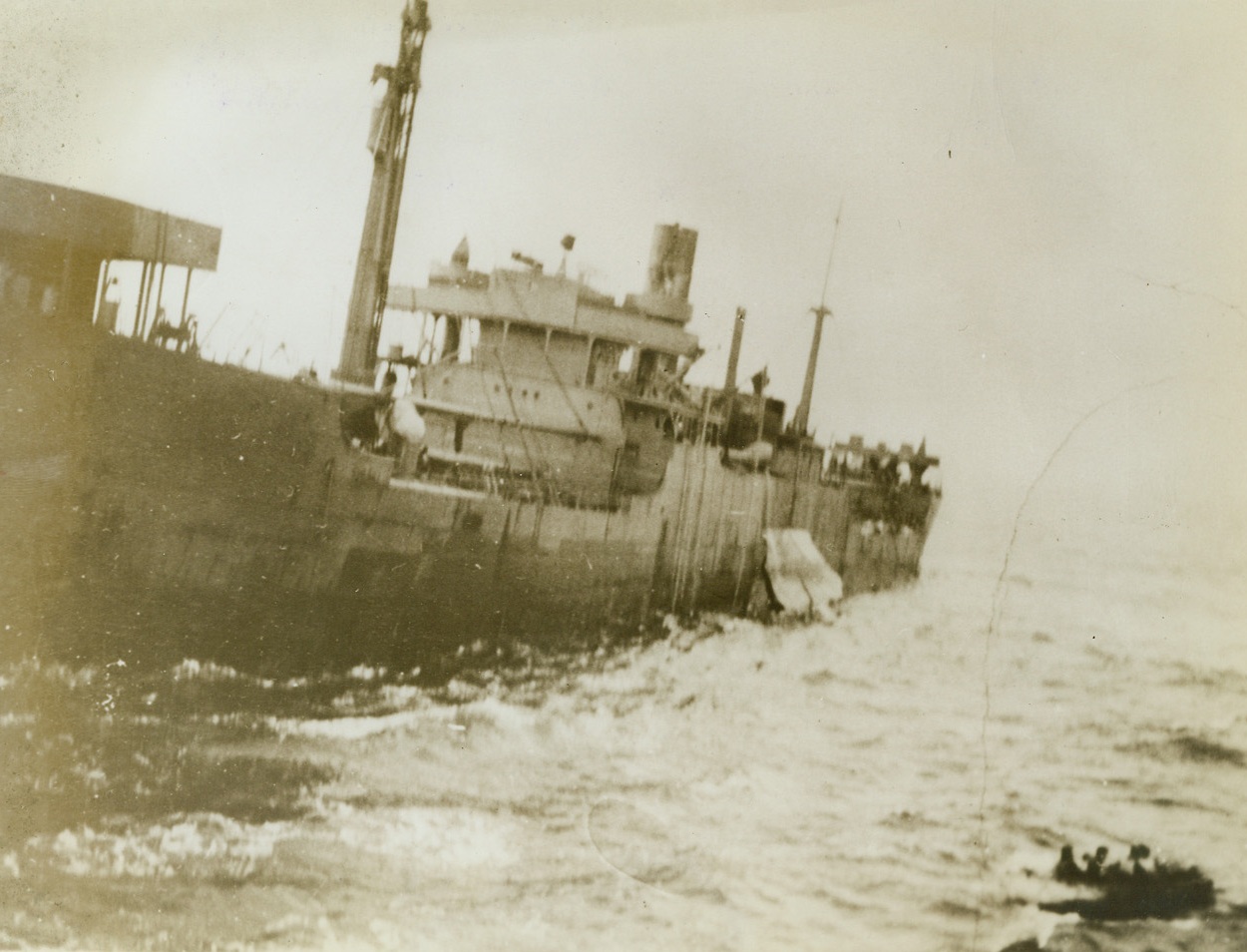 Rescued Crew, 11/12/1942. Somewhere in the Atlantic – Rescued members of the crew of a torpedoed freighter pull their lifeboat toward the United Nations vessel that picked them up. Their freighter remained afloat, menacing other ships, until it was sent to the bottom by depth charges from the rescue ship. Passed by censor. Credit: ACME;