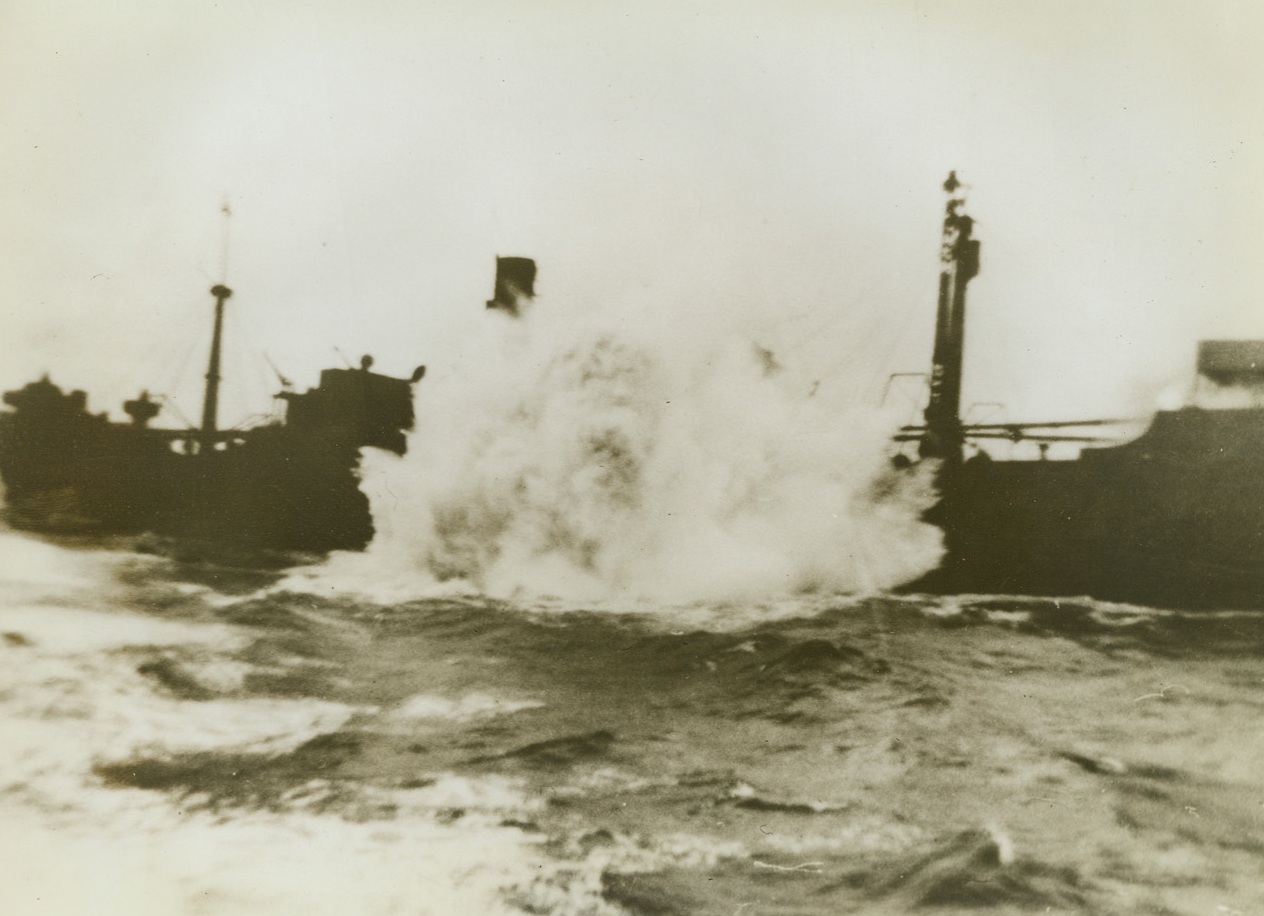 “Mercy Shot”, 11/12/1942. Somewhere in the Atlantic – A milky spray of sea water roars aloft as a depth charge from a United Nations vessel explodes against the hull of a freighter that had been torpedoed in the Atlantic. The ruined vessel was afloat and a menace to shipping, so the United Nations ship rescued its crew and sank the freighter. Passed by censor. Credit: ACME;