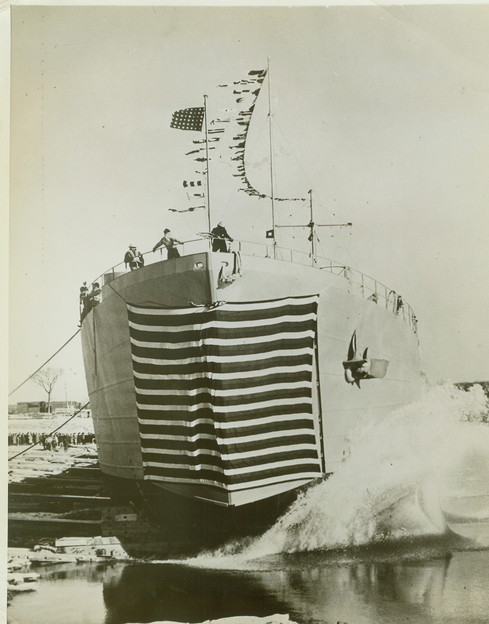 Tank Landing Vessel Launched by Woman Welder, 12/13/1942. SENECA, ILL. – A new tank landing vessel being launched at Seneca, Ill. plant of Chicago Bridge and Iron Co. in honor of the many women workers who helped build the ship Mrs. Harriet Williamson a welder for the company performed the christening ceremony. Credit: (ACME);