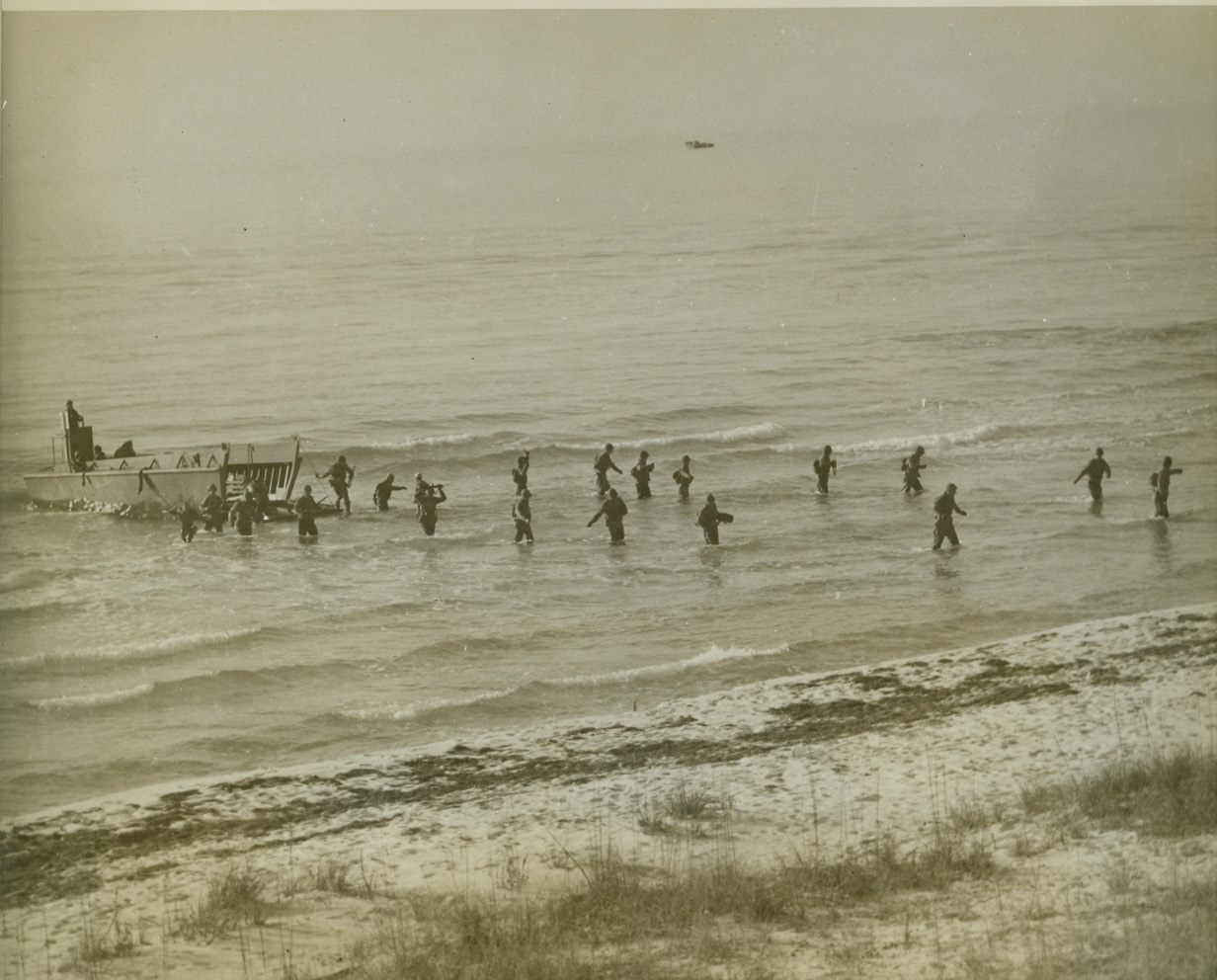 Amphibian Engineers Come Ashore (1), 12/20/1942. Camp Carrabelle, Fla.—Seagoing soldiers of the new Engineer Amphibian Command wade ashore from a landing boat during landing operations which were observed by Lieut. Gen. Leslie J. McNeir, chief of U.S. Army Ground Forces. The Engineer Amphibian Command is Uncle Sam’s latest in combat troops. Credit: ACME.;