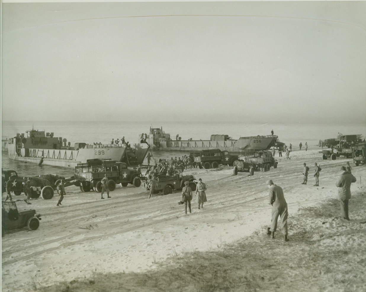 Amphibian Engineers Come Ashore (3), 12/20/1942. Camp Carrabelle, Fla.—General view of beach head established by Engineer Amphibian Command during practice landing operation near here. Note large landing boats used to bring ashore heavy vehicles, guns and supplies. Credit: ACME.;