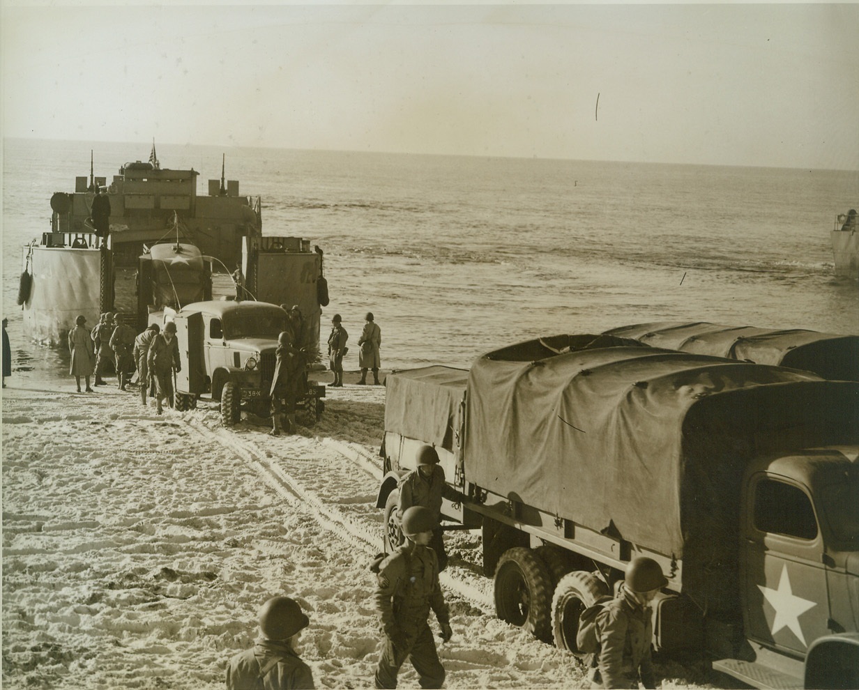 Amphibian Engineers Come Ashore (2), 12/20/1942. Camp Carrabelle, Fla.—Ten-wheel trucks, with guns and supplies trailing, roll off larger landing craft as the Engineer Amphibian Command stages a landing near this camp. This command is the newest in the Army. Credit: U.S. Army Signal Corps from ACME.;