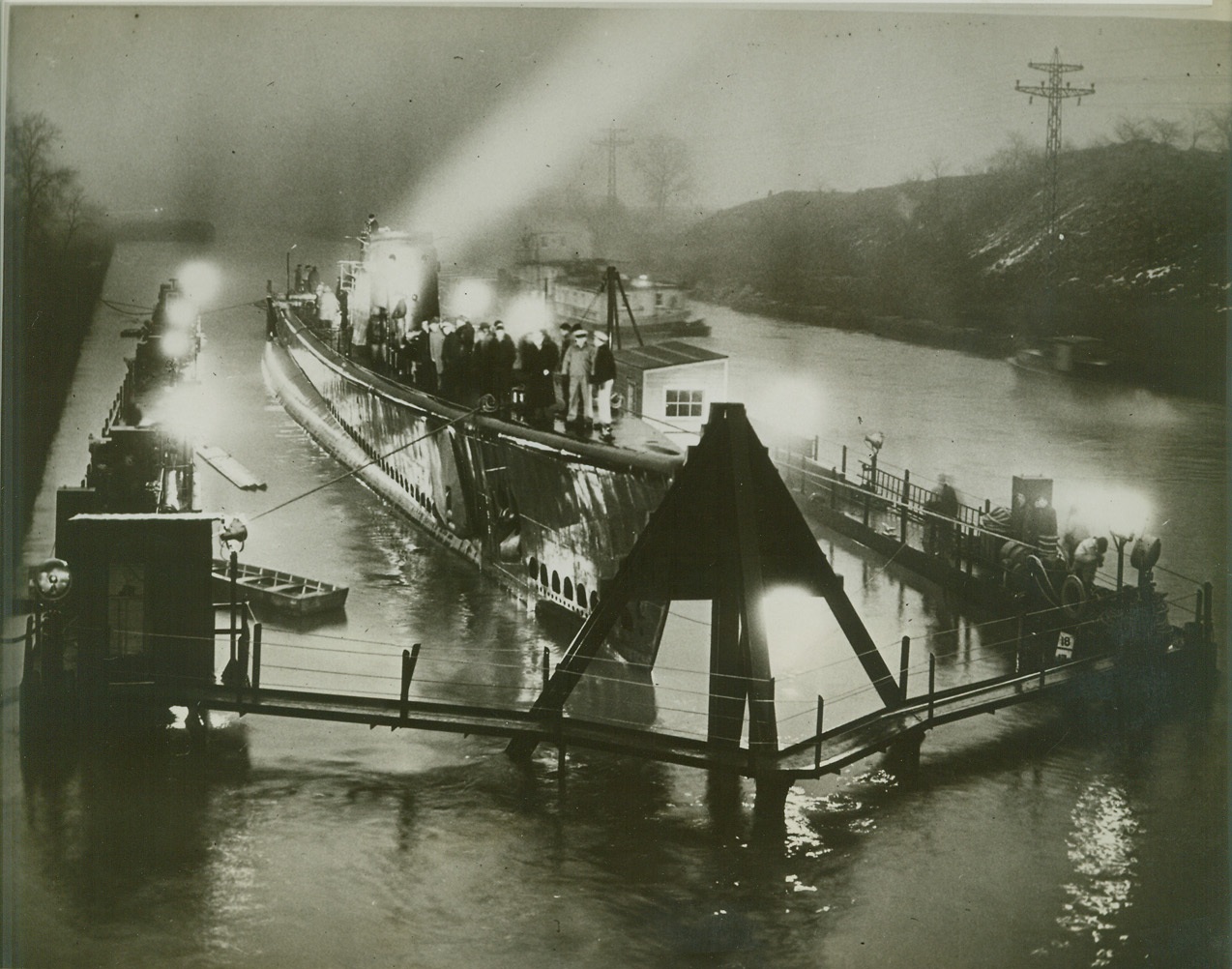 SUB BUILT ON GREAT LAKES NOW ON WAY TO THE SEA, 12/26/1942. CHICAGO; The U.S.S. Peto, the first U.S. Navy submarine ever built on the Great Lakes, is placed in a drydock at Lockport, IL for the trip to New Orleans, LA and the sea, over shallow lower reaches of the Illinois and Mississippi Rivers. The sub is being towed from Chicago through the inland waterways after tests and trial run from Manitowoc, Wis. Shipyards, where it was built. Credit: OWI Radiophoto from ACME;