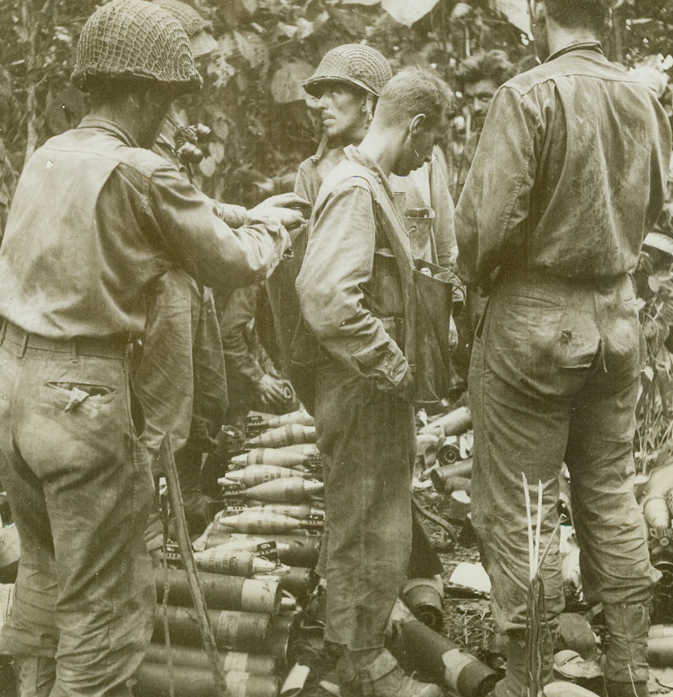 MOVING AMMUNITION FOR ATTACK ON JAPS, 12/15/1942. NEW GUINEA—Ammunition for three-inch trench mortars is loaded on the back of a pack carrier for transport to weapons set up in the jungles of New Guinea, as combined Australian and American forces under Gen. Douglas MacArthur advanced against the Japs in the Buna-Gona area. This photo has just been released in Washington. According today’s dispatches, both Buna and Gona are in the hands of the Allies and heavy fighting is continuing at Buna Mission. Japanese have landed in the Cape Ward sector.  Credit: ACME.;